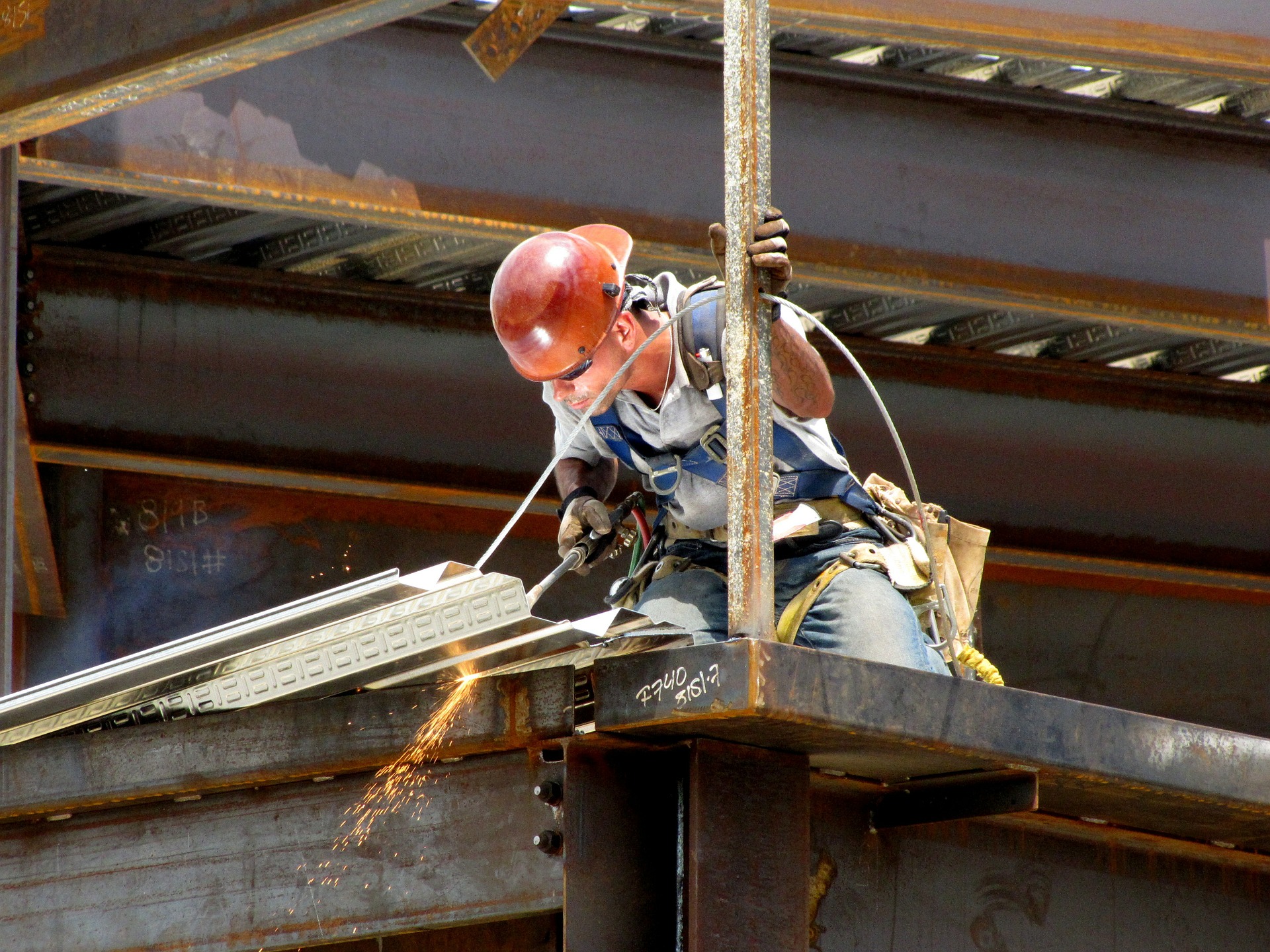 Ironworker cutting steel on a beam